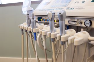 A dentistry rotary tool setup for endodontics, with a base and an array of hand sets.