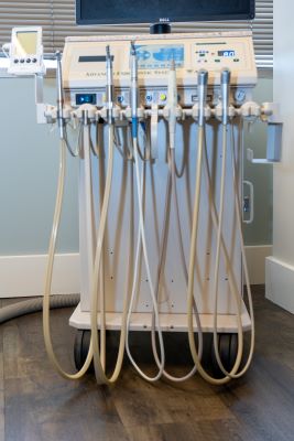 An array of ultrasonic instrumentation tools held in place by a console.